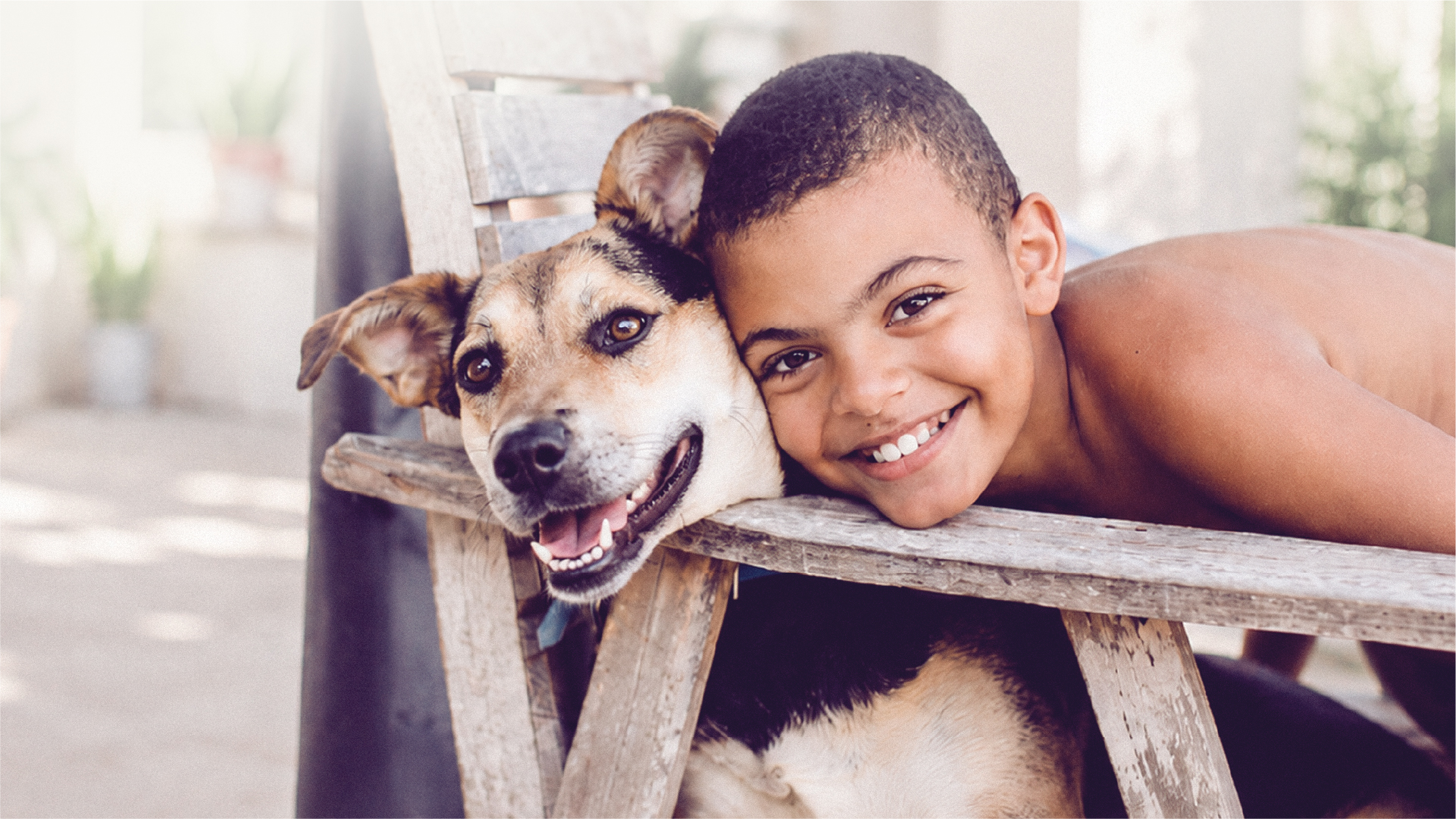 A boy resting beside his dog