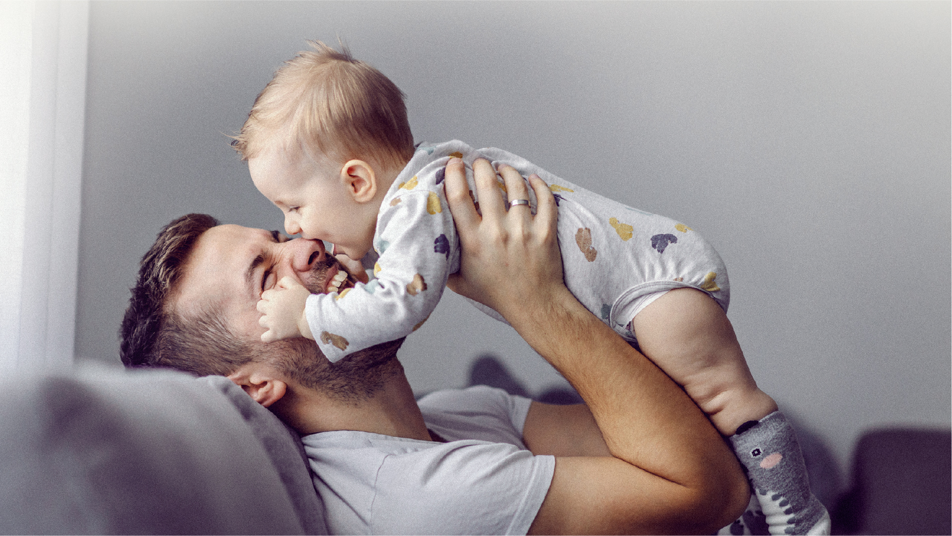 A father lifting his child into the air